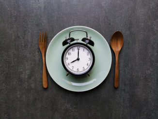 Food clock spoon and fork, Healthy food concept on black background