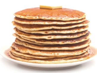 A plate of pancakes with butter on top