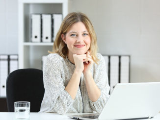 Businesswoman posing looking at you at office