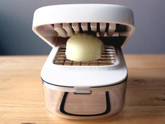 OXO Good Grips Vegetable Chopper with Easy-Pour Opening with an onion prepared for chopping