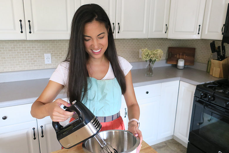 Dietitian Brittany Chin Jones using a Krups 10-speed mixer in her kitchen to make raspberry macarons