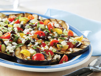 Plate of grilled eggplant with tomatoes and feta