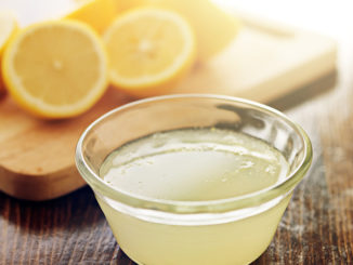 freshly squeezed lemon juice in small bowl shot close up