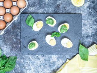 Parmesan Pesto Over Eggs on a slate serving board