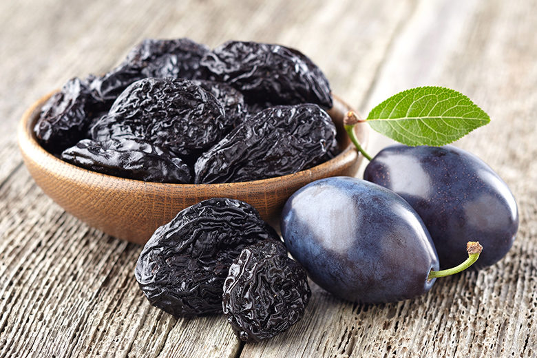 Plum with prunes on a wooden board