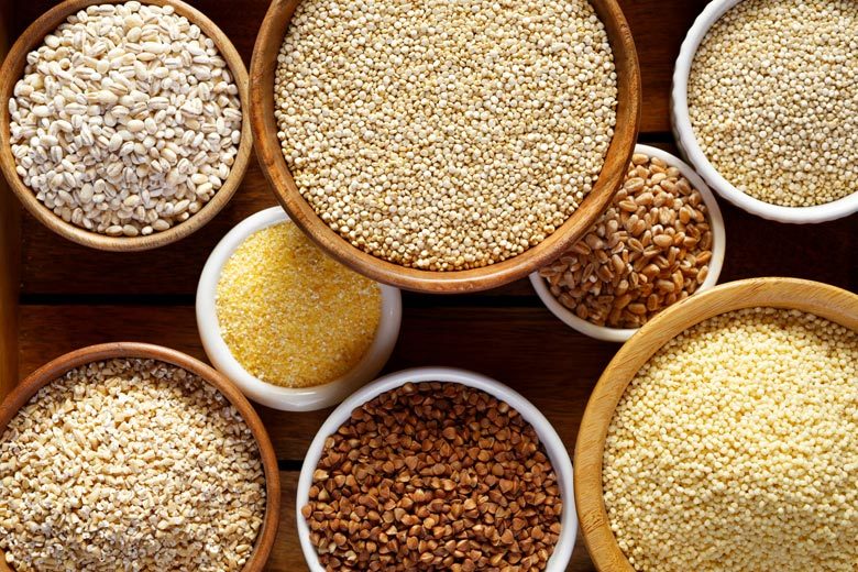 A variety of whole grains in different size bowls