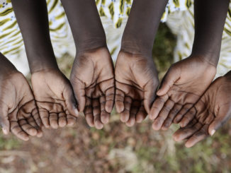 African children gather hands together