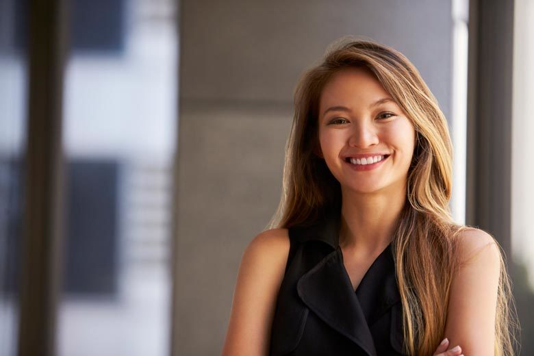 Young Asian woman smiling and confidently looking at camera